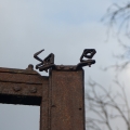 Brána Liblín detail ozdoby klapačky, smutný pohled 